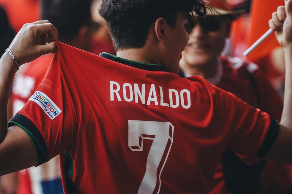 Ronaldo 2, Internet 0 A passionate soccer fan wearing a Ronaldo jersey celebrates at a sports event.